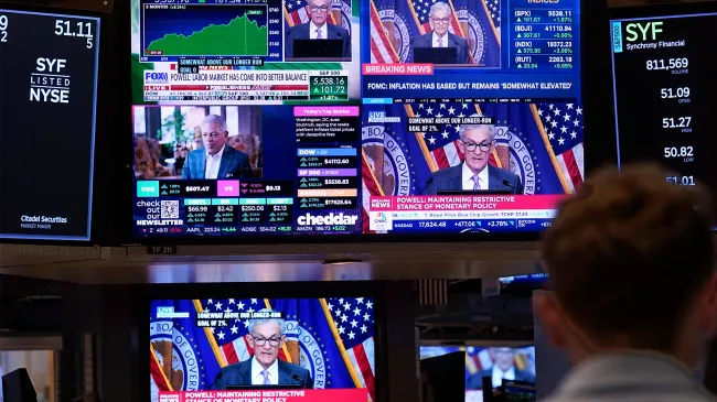 A bank of television screens on the floor of the New York Stock Exchange, shows Federal Reserve Chairman Jerome Powell